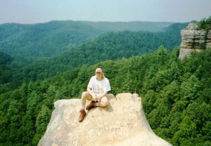 Kevin in his infamous pink hat sitting atop Half Moon at Red River Gorge, KY
